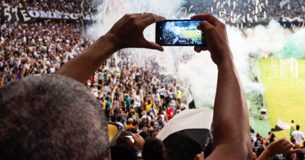 fan shooting authentic mobile sports moment in stadium